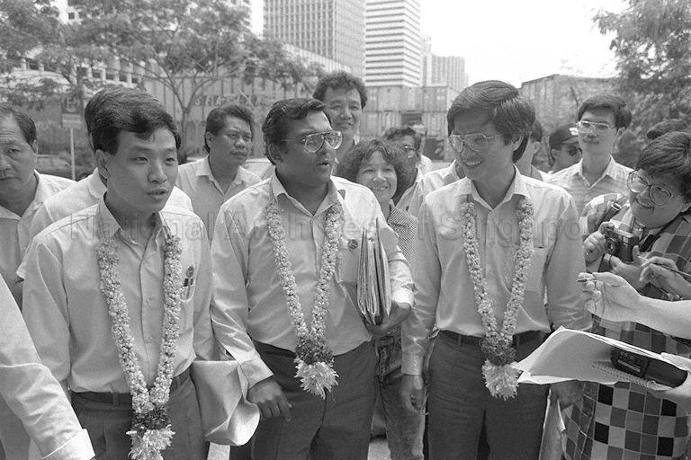 General Election 1988 - Workers' Party (WP) candidates for Tiong Bahru Group Representation Constituency (GRC) - (from left) Low Thia Khiang, Pallaichadath Gopalan Nair, and Lim Lye Soon being interviewed by the media at Singapore Conference Hall on nomination day for the General Election on 3 September 1988.