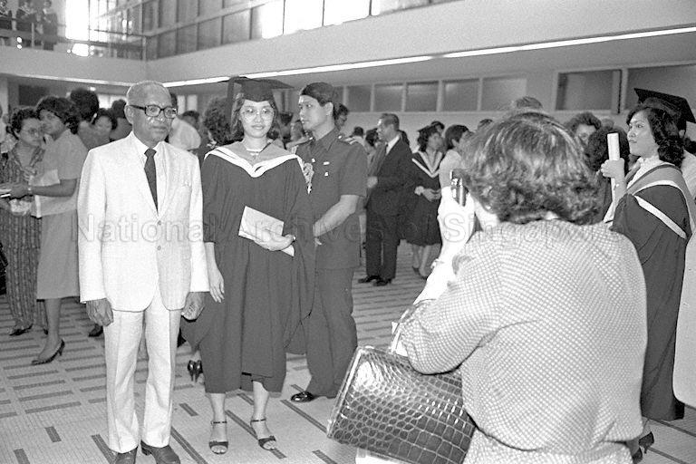 A female graduate posing for a photo with then President Devan Nair at an NUS convocation ceremony in 1983. Source: NAS