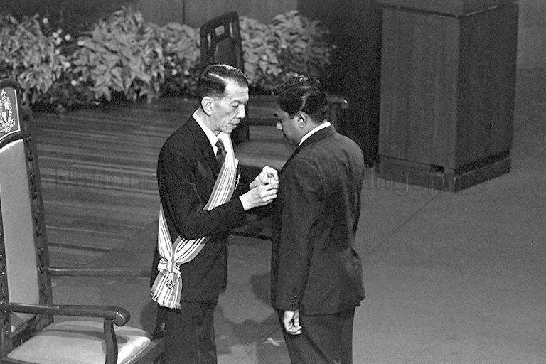 Director of Security and Intelligence division of Ministry of Defence S R Nathan receiving Meritorious Service Medal (Pingat Jasa Gemilang), the highest honour given in 1974, from President Dr Benjamin Henry Sheares at the investiture of 1974 National Day awards held at Singapore Conference Hall