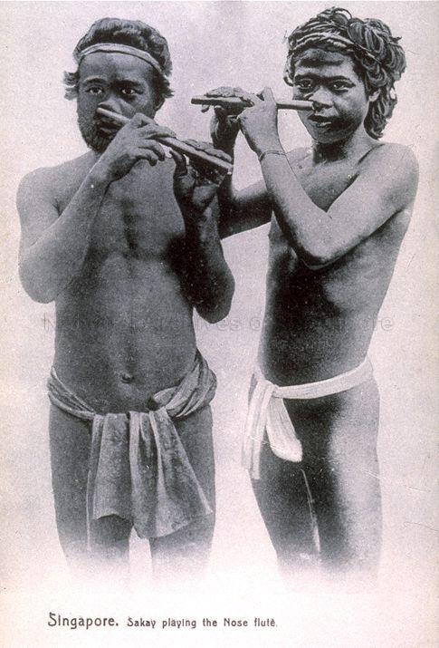 Indigenous people from the Sakai tribe playing nose flute, Singapore