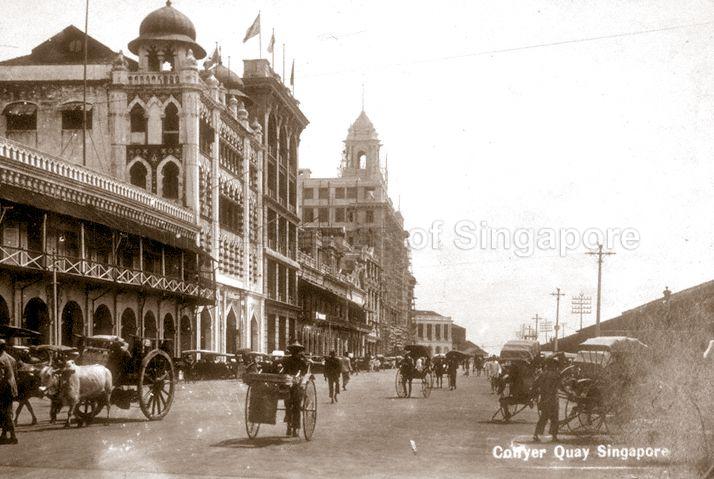 Collyer Quay with view of Alkaff Arcade (building with onion domes), the Union building (background) under construction and the Exchange Building (Fullerton Building) at the far end. Source: National Archives