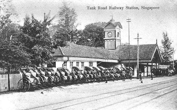 Tank Road railway station with jinrickshaws parked outside waiting for passengers. The station served as the main terminus for passenger trains coming down from the Woodlands jetty on the Singapore-Kranji Railway. Opened in 1903, the station was closed in 1932 when the Tanjong Pagar station opened.