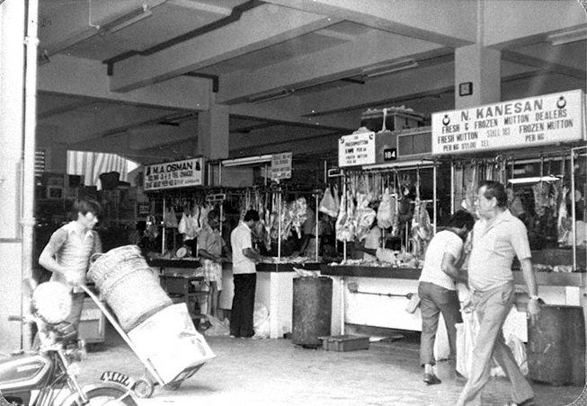 Stalls selling mutton at the newly-opened Zhujiao Centre or Tekka Centre (as it was renamed in 2000). The market was originally located between Hastings Road and Sungei Road, and first known as Kandang Kerbau (or just KK), Malay for "buffalo pens", referring to the slaughterhouses operating in the area until the 1920s. It was also known as Tek Kia Kha, in Hokkien where it means "foot of the small bamboos", because bamboo plants once grew on the banks of the Rochor Canal. Its name was later adapted to Tekka Pasar, where pasar is Malay for "market".