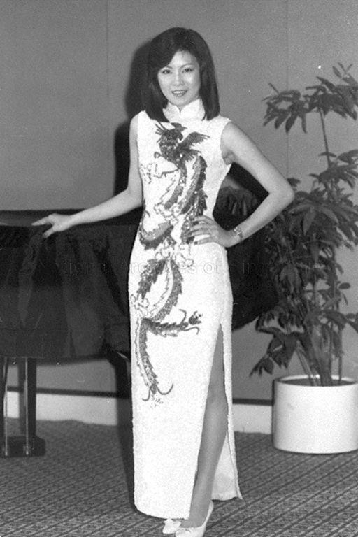 Contestant of Miss Direct Selling Association of Singapore (DSAS) pageant dressed in a long embroidered cheongsam posing for photograph at Meridien Hotel where the eighth anniversary dinner and dance of DSAS is held