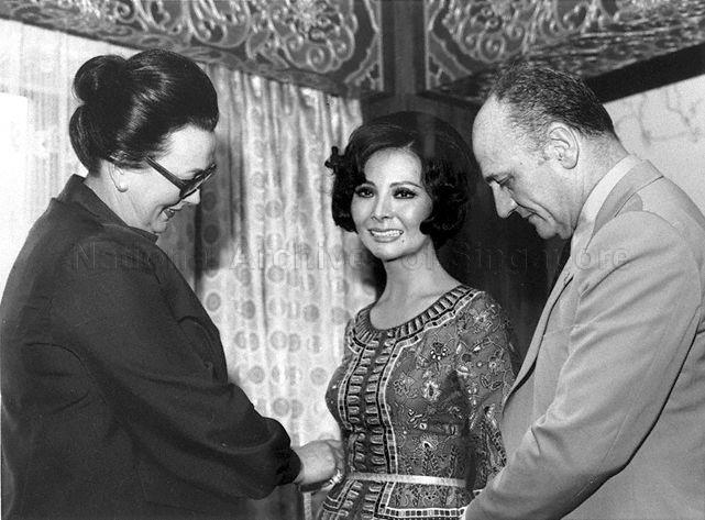 Miss See Biew Wah, stewardess with Singapore Airlines (SIA) and model for the Singapore Girl, seen here with French designer Pierre Balmain, creator of the sarong kebaya outfit with which the Singapore Girl is synonymous, and Madame Madeleine Kohler, Balmain's Director of Creations and Special Projects