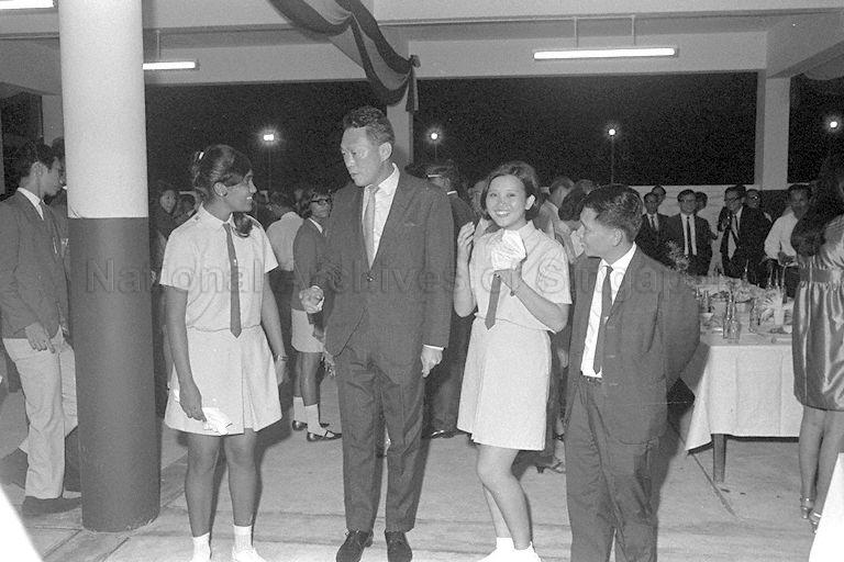 Prime Minister Lee Kuan Yew talking with students at official opening of National Junior College (NJC). On the right is NJC principal Lim Kim Woon.
