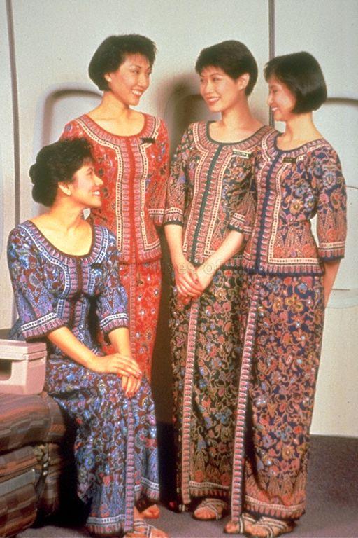 Singapore Airlines (SIA) flight stewardesses in their sarong kebayas designed by Pierre Balmain. The four different colours represent the difference in ranks -- (from right) blue for flight stewardess, green for leading stewardess, red for chief stewardess and burgundy for in-flight supervisor.