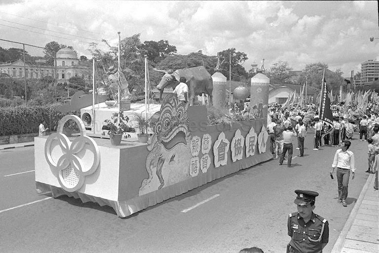 Float bearing the statue of a bull and two giant ornamental firecrackers leading the Chingay procession jointly organised by People's Association and National Pugilistic Federation