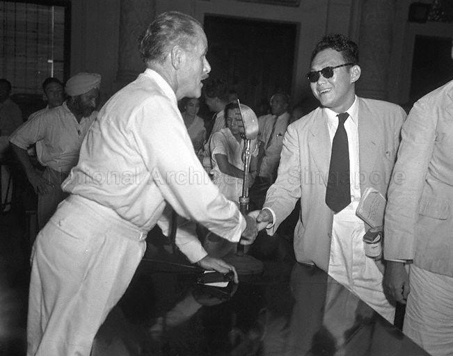 Singapore lawyer Lee Kuan Yew, counsel for Singapore Post and Telegraph Uniformed Staff Union, exchanging handshakes with Director of Posts, Singapore W A Cooper at the end of the arbitration proceedings between postal workers and the Government. The arbitrator from Kuala Lumpur, Yong Pung How, had awarded the workers 28 months' back pay.