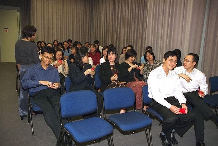 Participants at Gongxi Raya Celebration at Government Press Centre, Ministry of Information and the Arts, Port of Singapore Authority (PSA) Building. In 2000, Hari Raya Puasa was on 8 Jan and Chinese New Year was on 5 Feb.