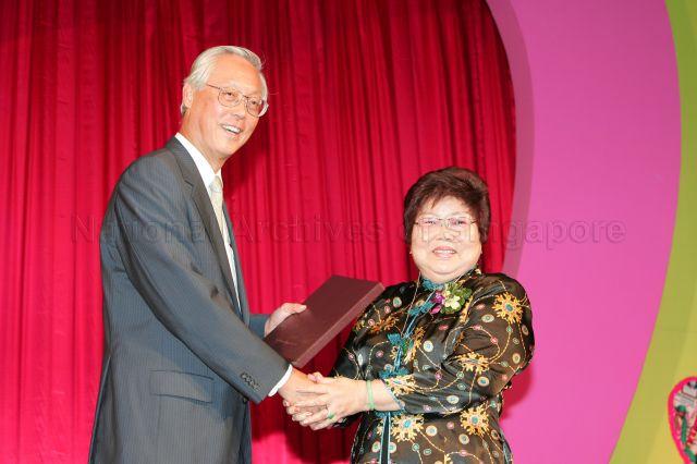 Senior Minister Goh Chok Tong presenting the book 'Tribute to Goh Chok Tong, Prime Minister of Singapore, 1990-2004' during Marine Parade charity dinner at Raffles City Convention Centre