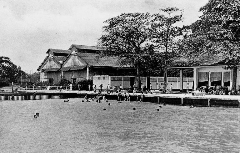 Katong Park bathing pagar, Singapore's first public sea swimming enclosure. It was opened on 19 December 1931 by W Bartley, President of the Municipal Commissioners. At 50 yards (about 45 metres) in length, extending 100 feet (about 30 metres) into the sea, it had 40 dressing rooms (white block with ventilation grooves in centre of photo). The place was closed in the 1960s when the coast was reclaimed.