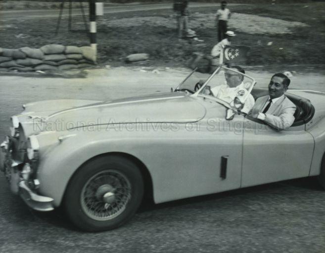 Yang Di-Pertuan Negara Yusof Ishak being driven round the course by F Pope, President of the Singapore Motor Club, at opening of the Grand Prix