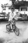 PHOTOGRAPH OF A BOY WITH A CHILD RIDING A BICYCLE