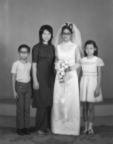 Full length portrait of bride and three siblings