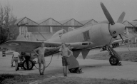 Photograph of two airmen posing with a Hawker Tempest