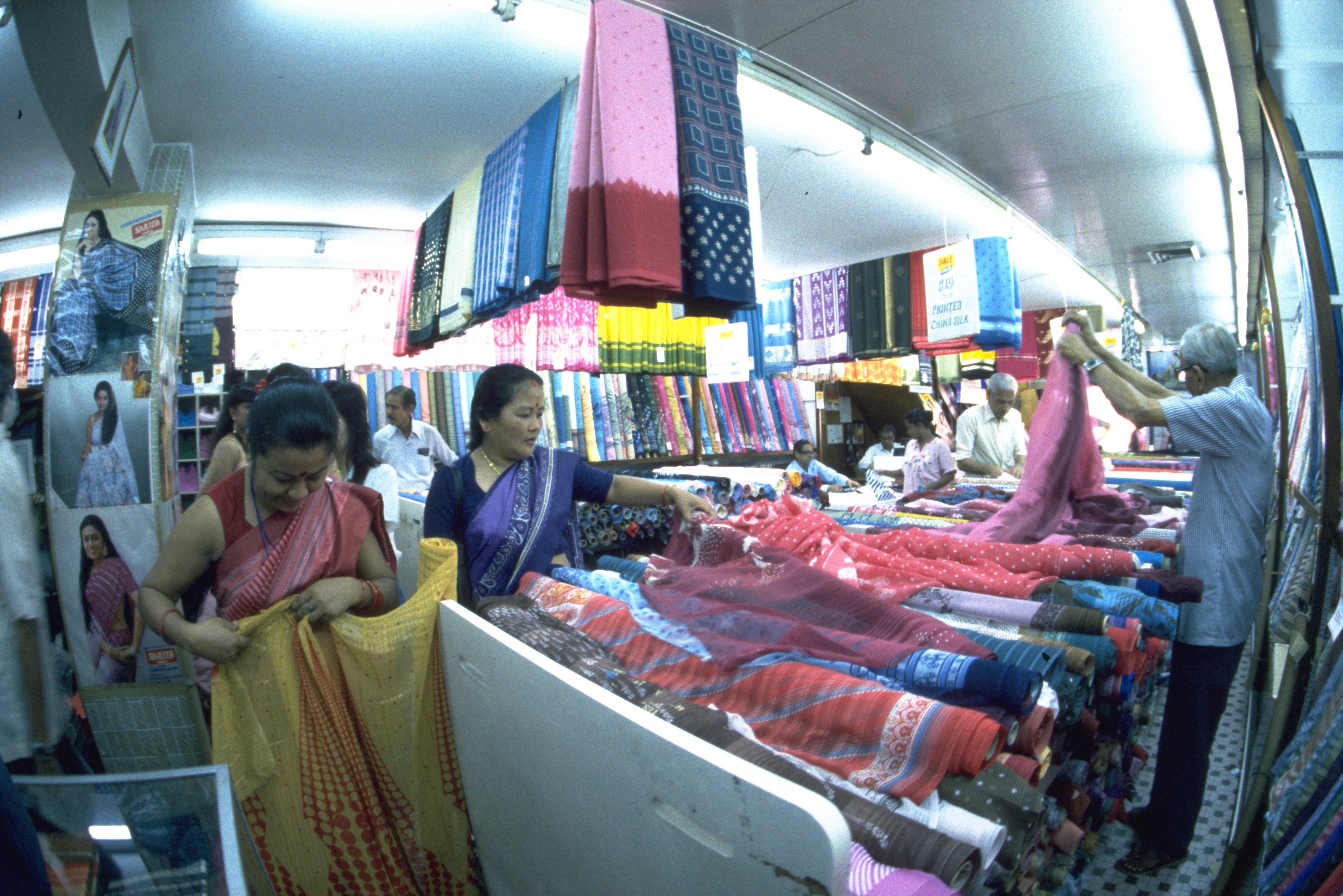Ladies selecting cloth for saris during Deepavali shopping in Serangoon Road area