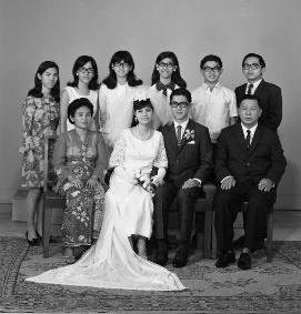 Full length portrait of wedding couple with group of eight, 20/05/1969