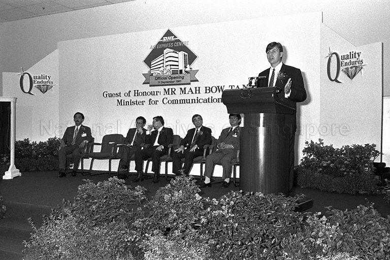 Mr Peter Flowers, then the Managing Director of DHL Express Singapore in 1991, speaking during opening of DHL Air Express Centre at Tai Seng Drive. Seated second from right are Regional Managing Director of DHL South-East Asia/South Pacific Operations Roger Bowie, co-founder of DHL Larry Hillblom and guest of honour Minister for Communications and Minister of State for Trade and Industry Mah Bow Tan.