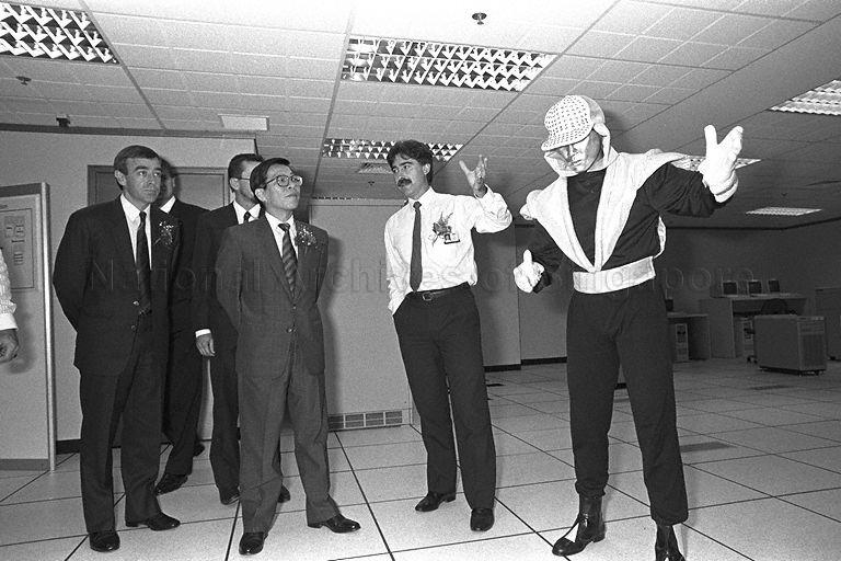 DHL Air Express Centre official briefing Minister for Communications and Minister of State for Trade and Industry Mah Bow Tan (second from left) during his tour of DHL Air Express Centre at Tai Seng Drive during its opening. The Minister is accompanied by Regional Managing Director of DHL South-East Asia/South Pacific Operations Roger Bowie (left).