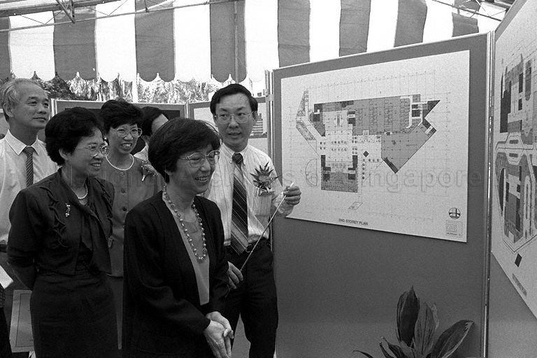 Minister of State for Health Dr Aline Wong (centre) being shown the floor plan of Institute of Health and National Dental Centre at First Hospital Avenue during ground breaking ceremony