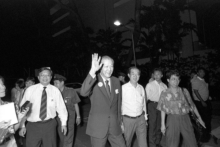 Presidential candidate Chua Kim Yeow (in suit) waving to supporters as he makes his way to Singapore Conference Hall, the principal counting centre for the first presidential election
