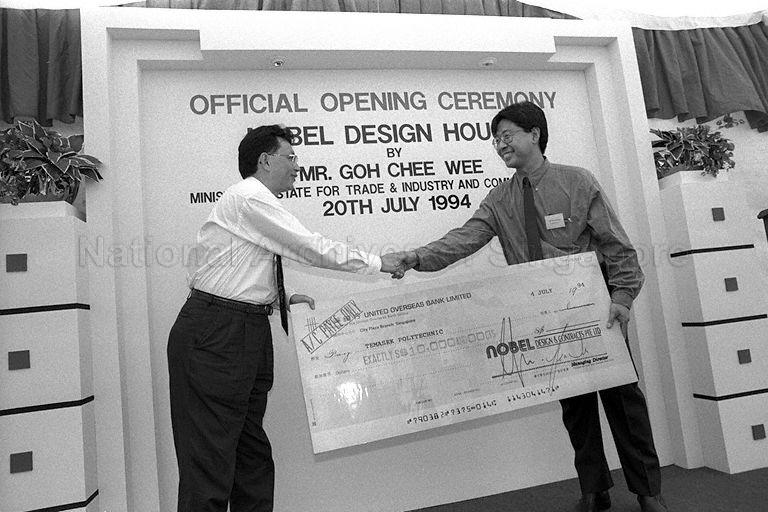 Managing Director of Nobel Group Bert Choong (left) presenting cheque to representative from Temasek Polytechnic during opening of Nobel Design House, the new regional headquarters of Singapore-based manufacturer and designer of furniture, at 134 Joo Seng Road