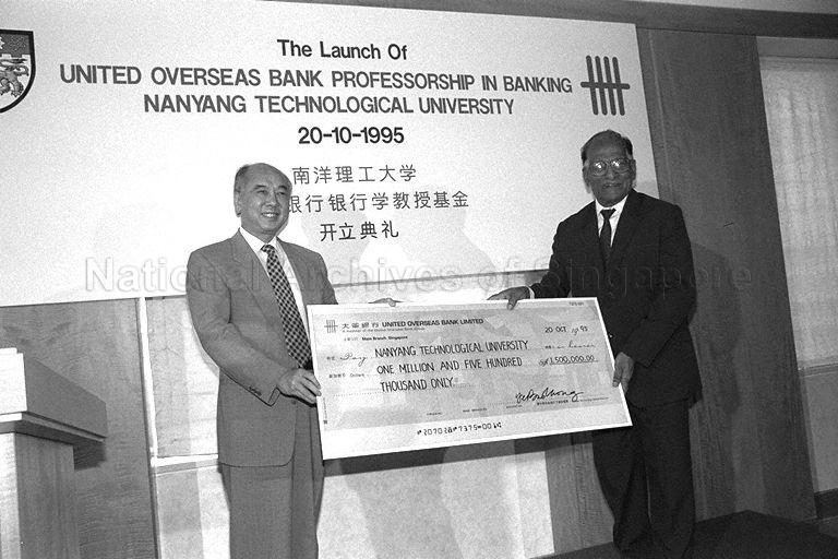 Chairman of United Overseas Bank (UOB) Wee Cho Yaw presenting donation cheque to Pro-Chancellor of Nanyang Technological University (NTU) Dr Vijiaratnam during launch of UOB professorship in banking at NTU held at UOB Plaza penthouse