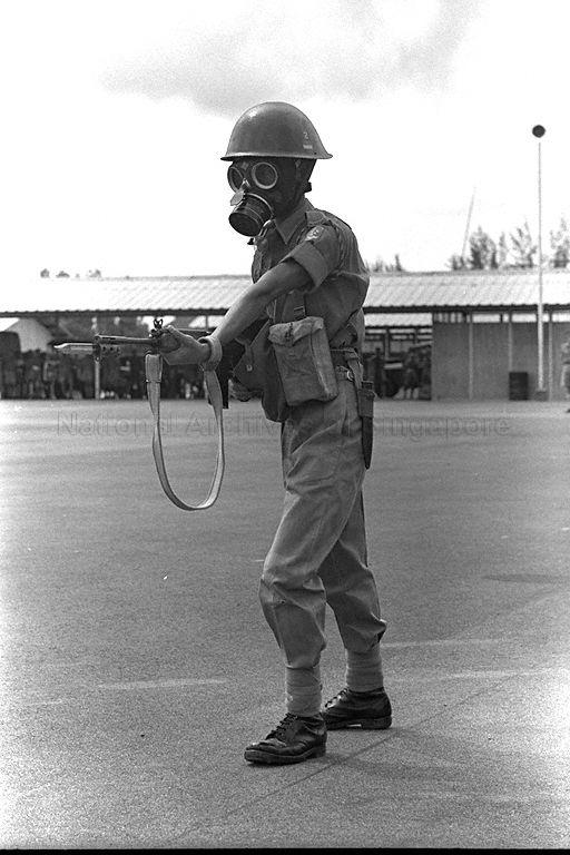 Soldier wearing gas mask at mock display during Yang di-Pertuan Agong's visit to Bukit Timah garrison, Temasek camp and Ulu Pandan camp