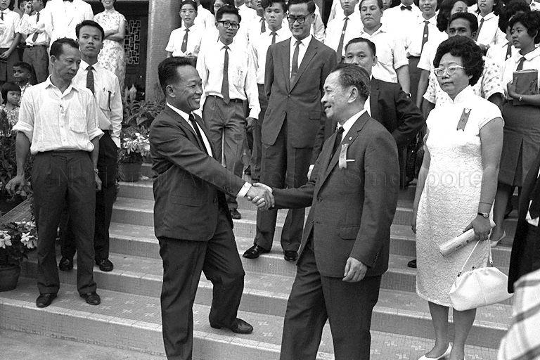 Minister for National Development Tan Kia Gan being welcomed when he arrives for inauguration ceremony of Ngee Ann College at Teochew Building, Tank Road. Looking on is Minister for Education Yong Nyuk Lin (centre).