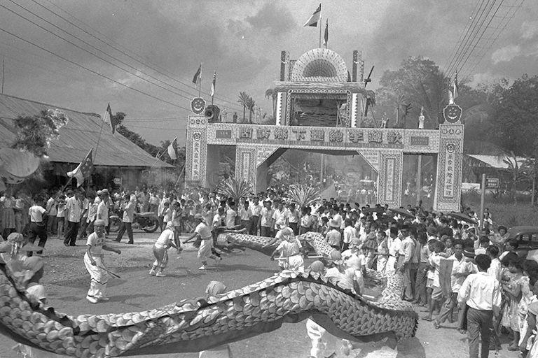 STREET SCENE OF A DRAGON DANCE PERFORMANCE WELCOMING PRIME