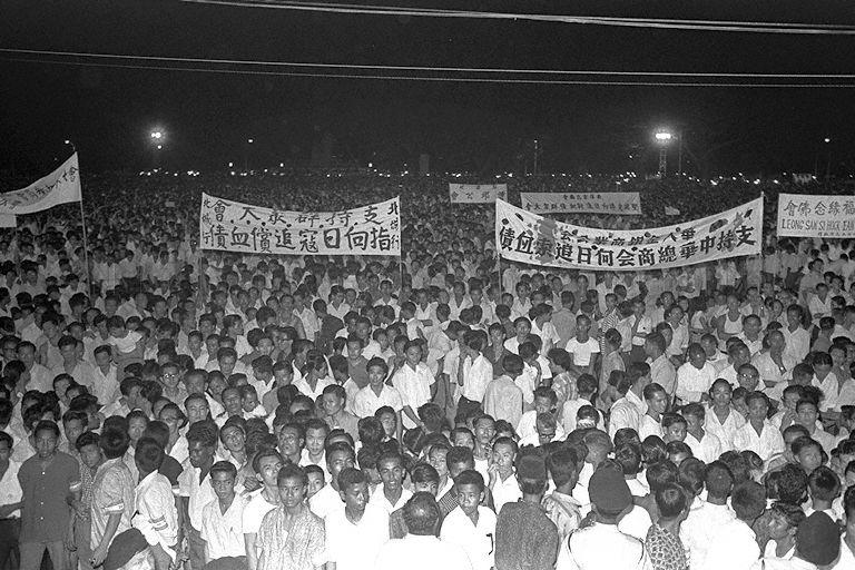Rally of more than 100,000 people of all races at the Padang organised by Chinese Chamber of Commerce to press for reasonable settlement of a Japanese atonement gesture for wartime atrocities
