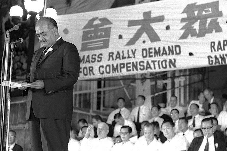 President of the Singapore Indian Chamber of Commerce D T Assomull speaking at the blood debt mass rally held at Padang