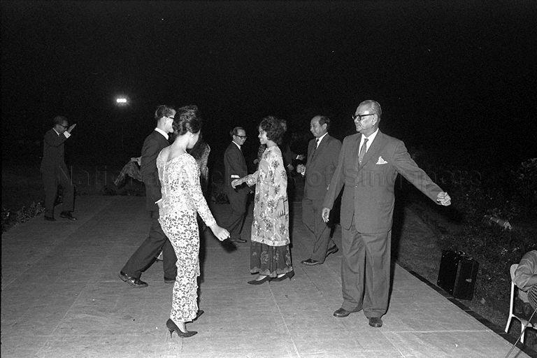 Malaysian Prime Minister Tengku Abdul Rahman (right) and Minister for Finance Dr Goh Keng Swee (second from right) dancing the joget during opening of Rumah Temasek at Kuala Lumpur