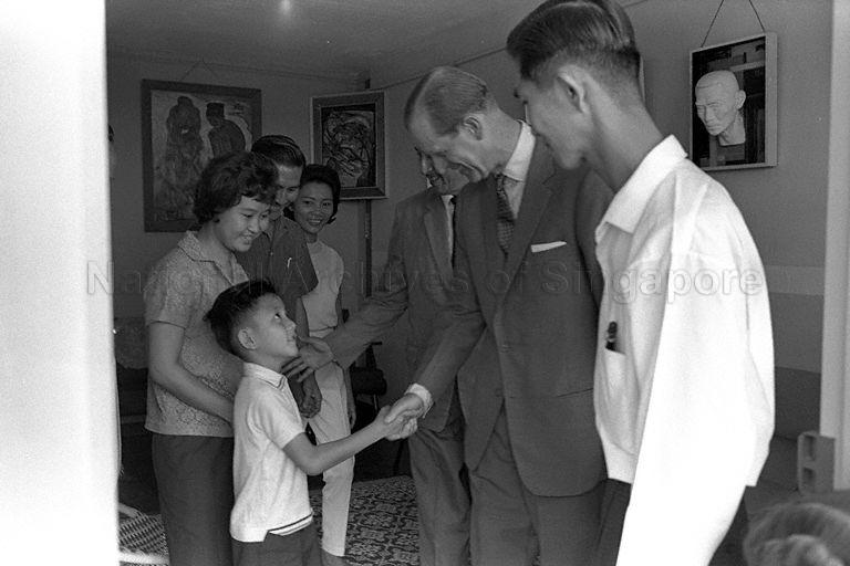 Duke of Edinburgh Prince Philip visits the See family in their flat at Queenstown during his two-day state visit to Singapore