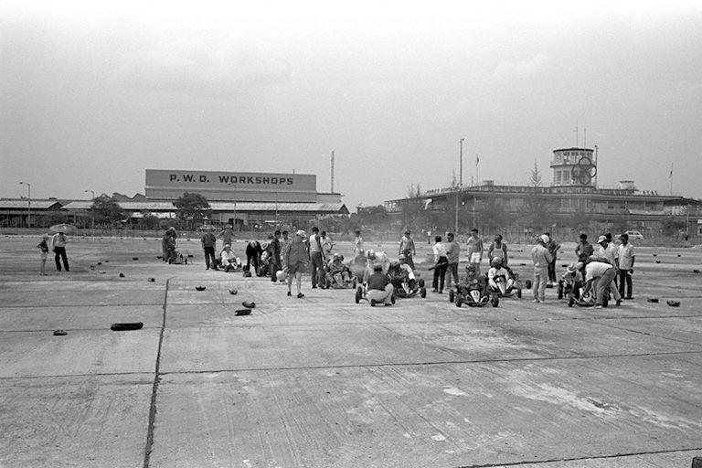 Go Kart racing at Kallang Park held in conjunction with Singapore's "Tourist Week". In the background are Public Works Department (PWD) Workshops and old Kallang Airport terminal building which serves as headquarters of the Peopleâ€™s Association.
