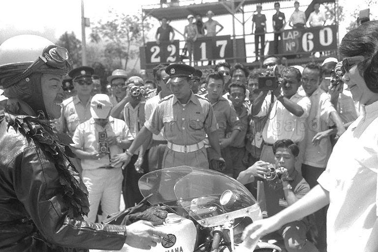Hiroshi Hasegawa, winner of the Motor-cycles 250cc event, being congratulated during the fourth Malaysia Grand Prix (also known as Malaysian Grand Prix)
