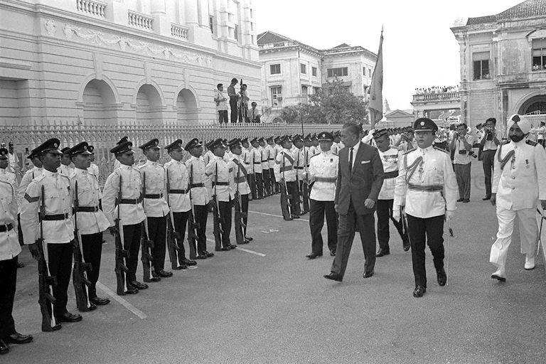 President Yusof Ishak inspecting the guard of honour from the Singapore Infantry Regiment during ceremonial opening of Parliamentary session. Yusof Ishak was officially designated President through Constitution (Amendment) Bill on 22 December 1965.