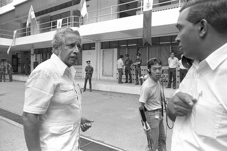 Workers' Party's (WP) Secretary-General J B Jeyaretnam (left) is brought to Raffles Institution as WP objects against two People's Action Party (PAP) candidates - Dr Yeo Ning Hong (Kim Seng) and Koh Lam Son (Telok Blangah) who submitted carbon-copied forms instead of originals.