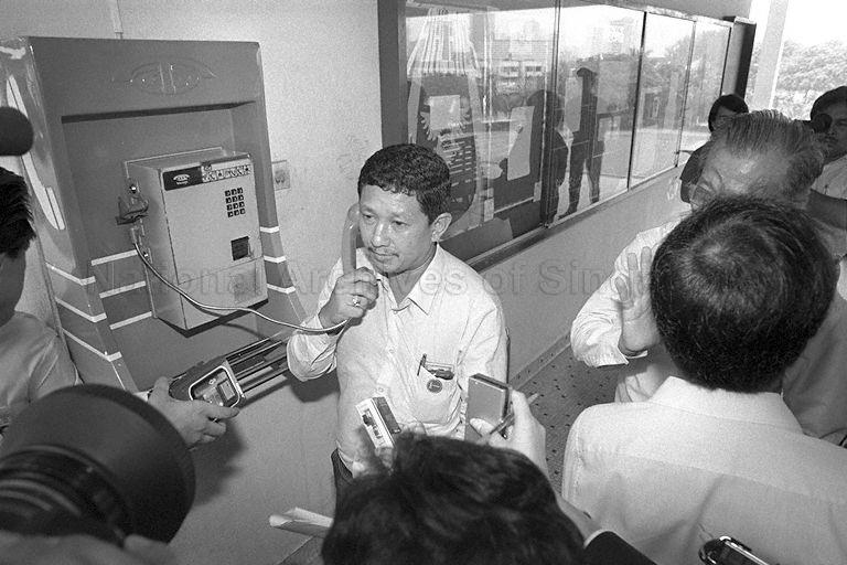 Workers' Party (WP) candidate for Leng Kee constituency Peter Chua Chwee Huat being surrounded by the media while he is on the public telephone at Raffles Institution on nomination day. General Election 1988 is on 3 September.