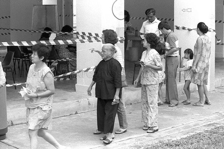 Elderly ladies joining queue to vote at void deck poll station during General Election 1988