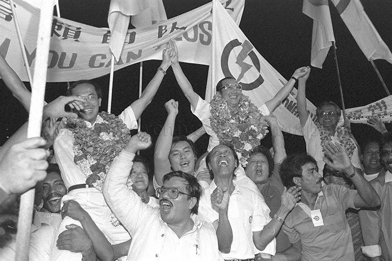 General Election 1988 - People's Action Party (PAP) candidates for Aljunied Group Representation Constituency (GRC) celebrating their victory with supporters at Geylang Methodist Secondary School counting centre. From left are (garlanded) Brigadier-General George Yeo Yong-Boon, Chin Harn Tong, and Wan Hussin Haji Zoohri.