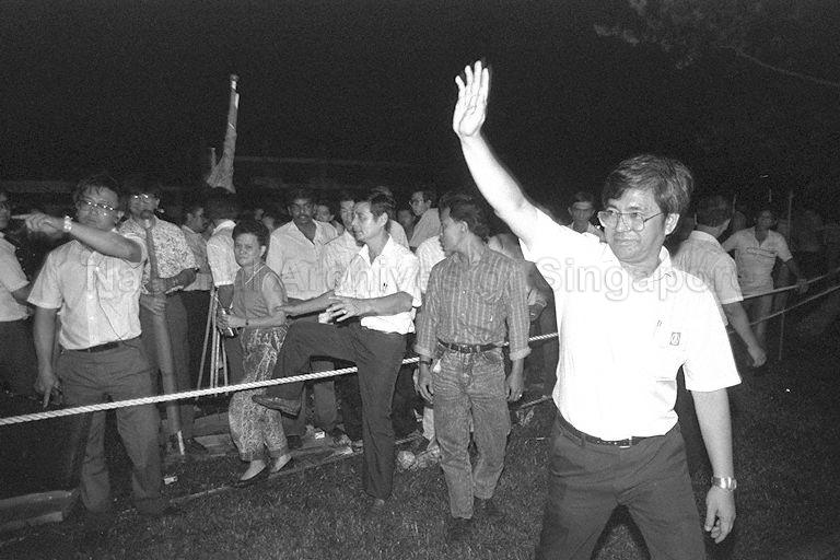 General Election 1988 - Singapore Democratic Party (SDP) candidate for Buona Vista constituency Low Yong Nguan (right) waving to supporters outside Jin Tai Secondary School counting centre