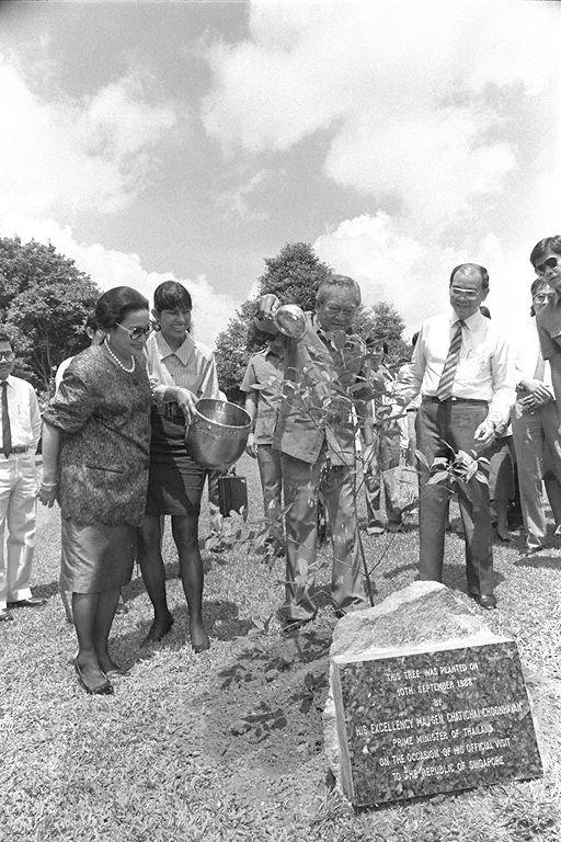Thai Prime Minister Chatichai Choonhavan, who is on a three-day visit to Singapore, watering a sapling he planted at the grounds of Jurong Town Corporation (JTC). Among those looking on are his wife Khunying (Lady) Boonruen and JTC General Manager Francis Mak.