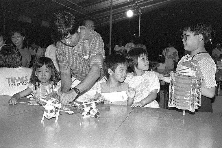 Parent lighting up lanterns for his children at Townsville Primary School