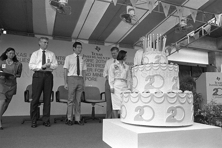 (Second from left) President of Texas Instruments (TI) Worldwide Semiconductor Group Pat Weber; BG Lee; TI Singapore Managing Director David Smith; and Chairman, President and Chief Executive Officer of TI Inc Jerry Junkins (behind the cake) at cake-cutting ceremony during TI's twentieth anniversary celebrations at its Bendemeer plant.