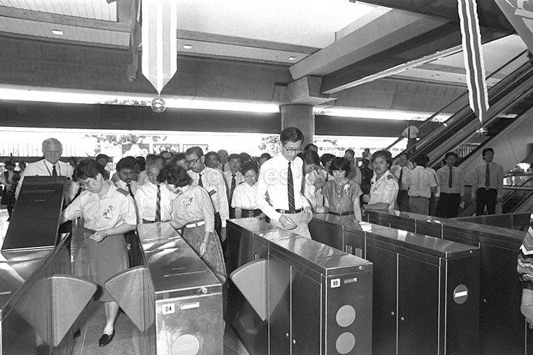 Member of Parliament for Nee Soon South Dr Koh Lip Lin (centre), who is also Political Secretary to Prime Minister's Office, and guests passing through the fare gate after the inaugural train ride from Yishun station to Ang Mo Kio and back.