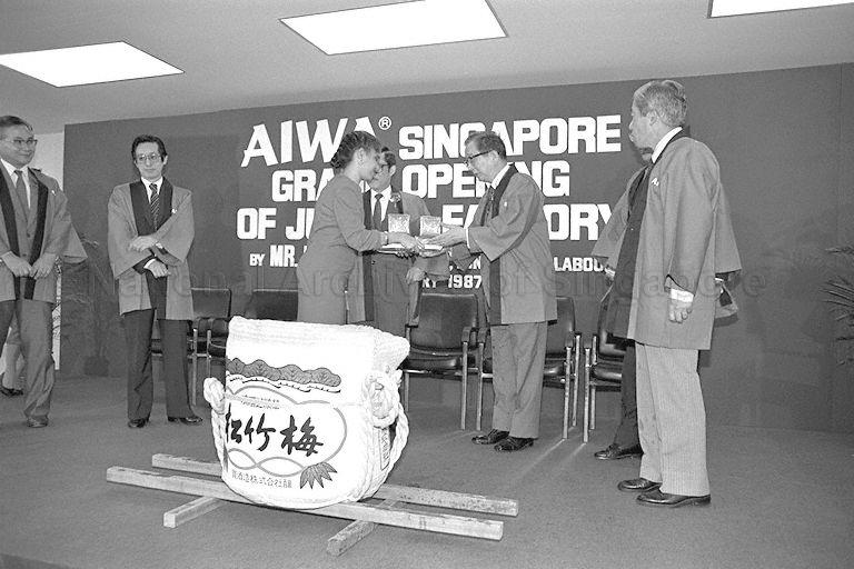 President of Aiwa Co Dr Heitaro Nakajima being handed gifts for the VIP guests