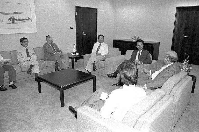 Deputy Director of the United States (US) Information Agency Marvin Stone and his team paying a courtesy call on Communications and Information Minister Dr Yeo Ning Hong at Port of Singapore Authority Building. Clockwise from left are Deputy Director of Singapore ministry's Information Division Tao Yeoh Chi (partially hidden), Singapore Director of the US Information Service Richard Gong, US Embassy Charge d'Affaires Peter Higgins, Director of the Singapore ministry's Information Division James Fu, Dr Yeo, Mr Stone and Dr Yeo's Press Secretary Martin Marini (backview).