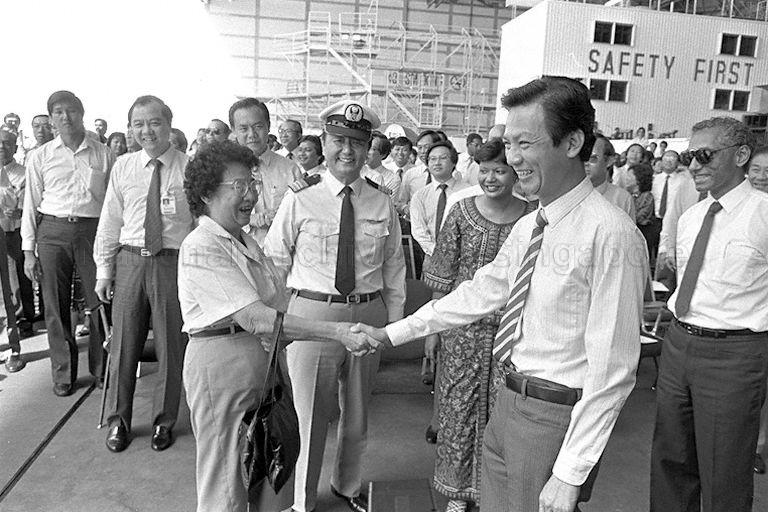 Rosemary Tay, who joined the airline in 1947 and became its first stewardess when it began as Malayan Airways, greeting Minister for Communications and Information and Second Minister for Defence (Policy) Dr Yeo Ning Hong at the launch of SIA's 40TH anniversary celebrations at its engineering hangar.